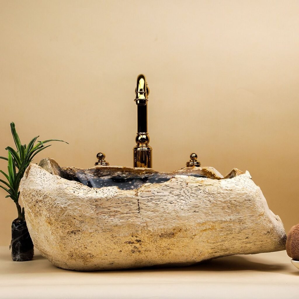 Natural stone wash basin carved from a single rock block, paired with a premium faucet in a luxury modern bathroom setup.