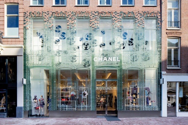 Chanel boutique in Amsterdam with a striking storefront constructed from glass bricks, showcasing luxury design and urban architecture.