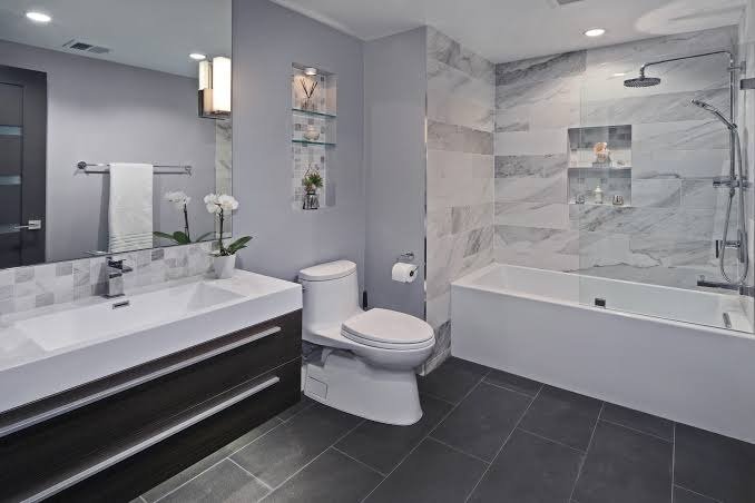 Small bathroom redesign ideas using light-colored beige and ivory tiles with a glossy finish to make the compact bathroom look brighter and more spacious.
