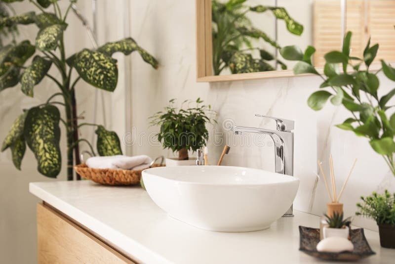 Small bathroom redesign ideas incorporating natural elements like wood-finish tiles, bamboo baskets, and indoor plants to add warmth and freshness to the space.
