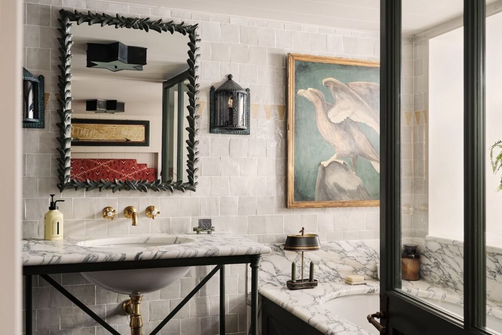 Small bathroom redesign ideas showcasing layered lighting with warm LED lights, mirror illumination, and glossy tiles to create a bright and luxurious ambiance.