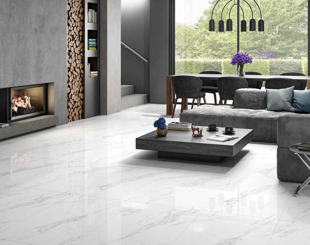Spacious living room featuring glossy marble-look vitrified tiles that enhance brightness, paired with contemporary furniture and a sleek fireplace design.
