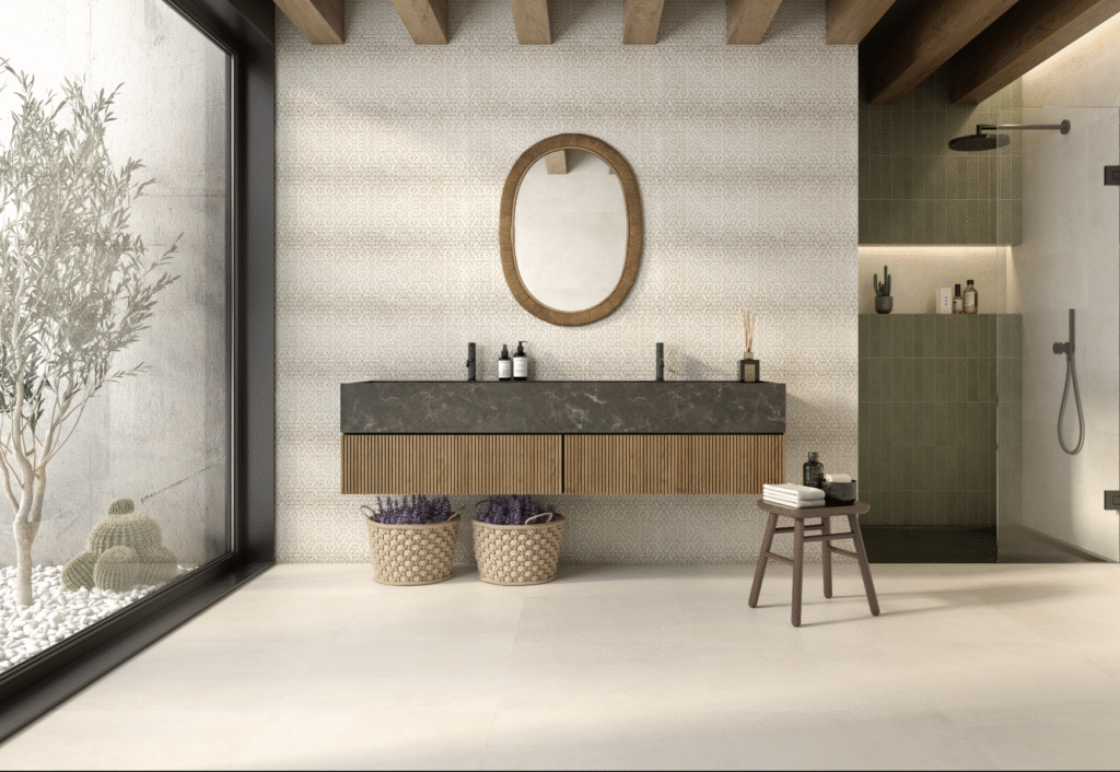 Bathroom interior featuring patterned wall cladding tiles paired with wooden vanity and earthy tones for a natural aesthetic.