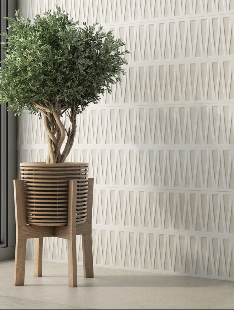 Close-up of triangular textured wall cladding tiles in cream color highlighting modern design and smooth finish.
