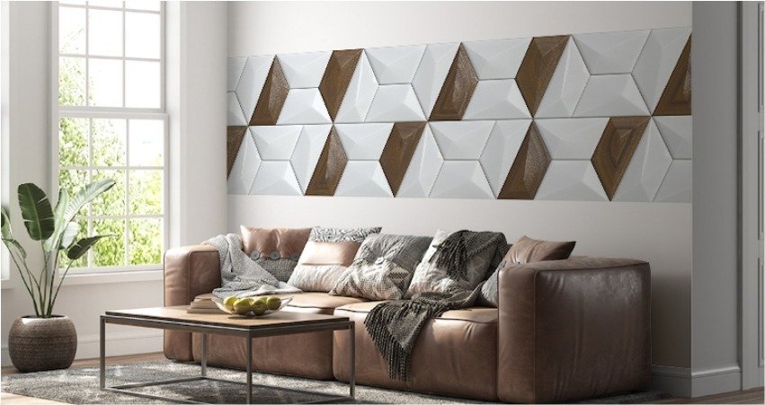 Modern living room with decorative luxury wall tiles featuring 3D geometric design in white and brown, complementing a neutral sofa and sunlight-filled interior in Gurgaon.