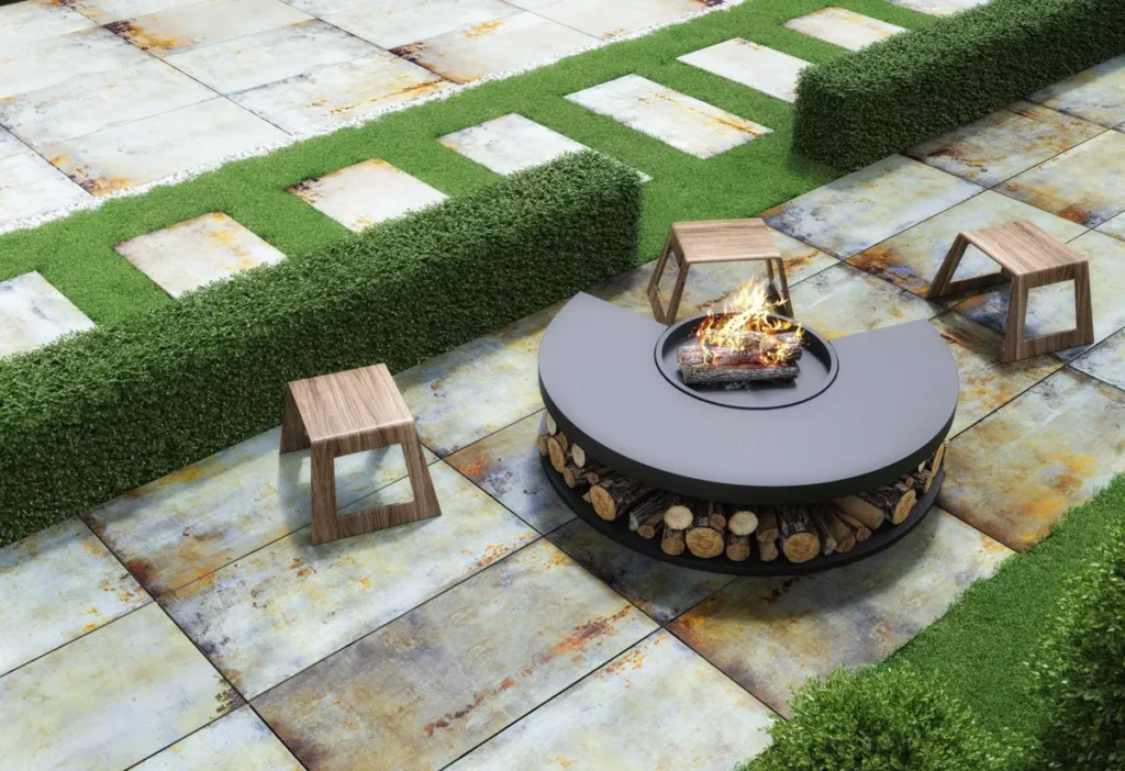 Industrial-style terrace tiles with a weathered finish surrounding a modern outdoor firepit and garden seating.