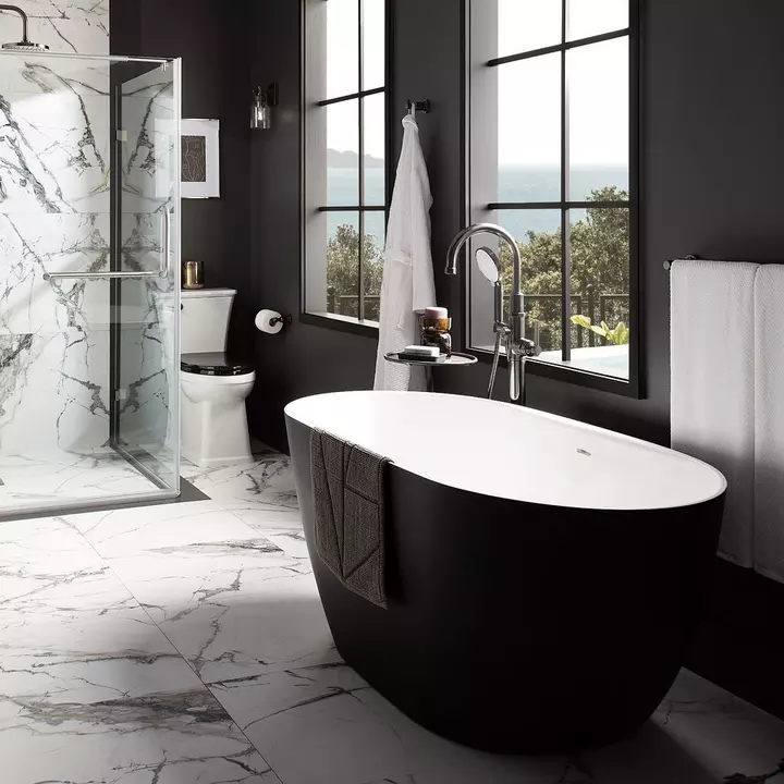 Contemporary bathroom with matte black bathtub and premium sanitaryware fittings on marble flooring