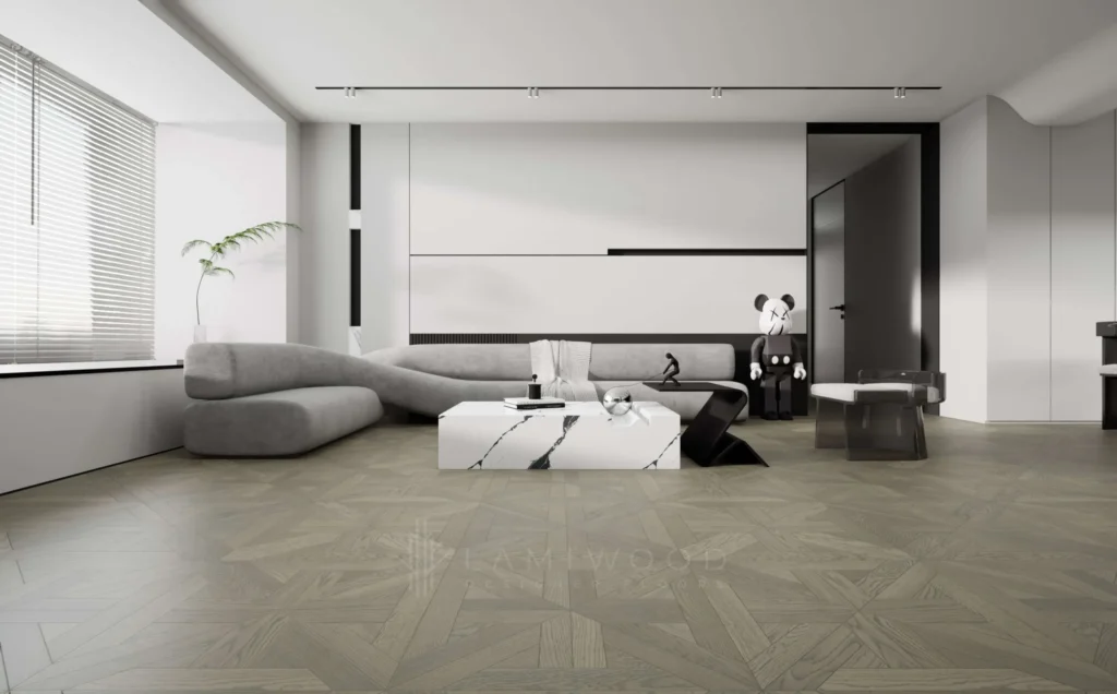 Minimalist modern living room with sculptural sofa, monochrome décor, and subtle grey wooden floor tiles in a designer pattern.
