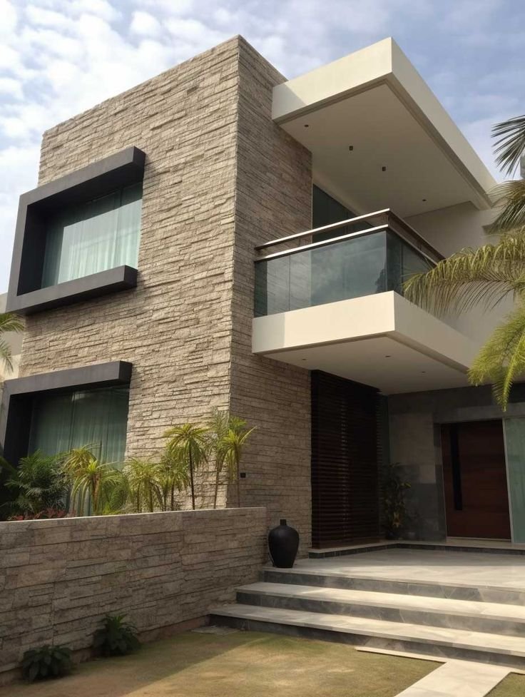 Luxury villa exterior enhanced with elegant stone outdoor wall cladding and modern balcony architecture.
