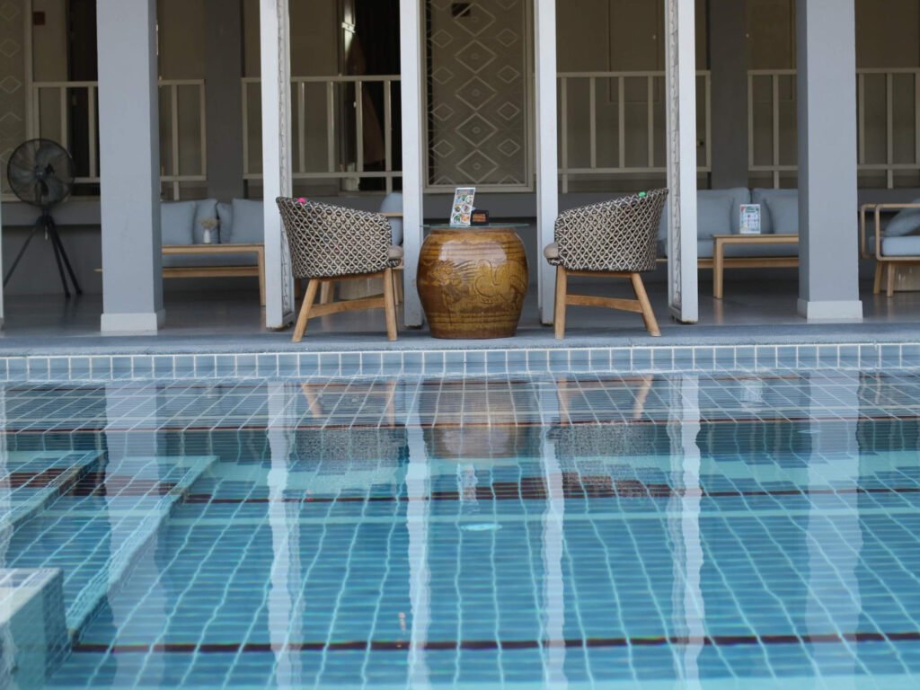 Luxury poolside tiles with geometric blue mosaic pattern creating a refined resort-style swimming pool experience
