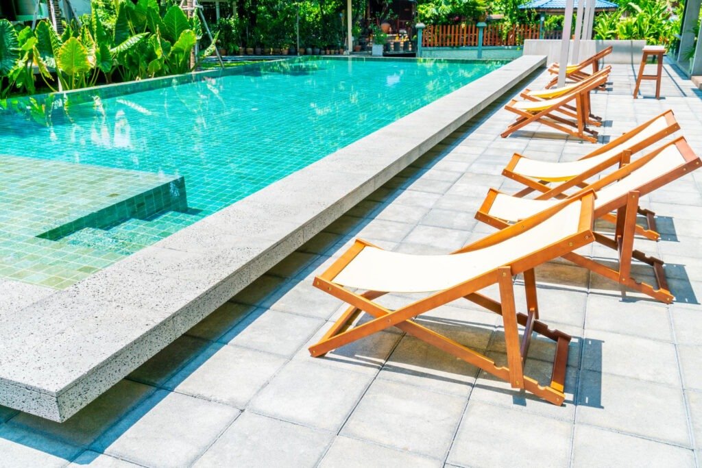 Resort-inspired poolside tiles in aqua hues delivering durability, comfort, and timeless outdoor sophistication