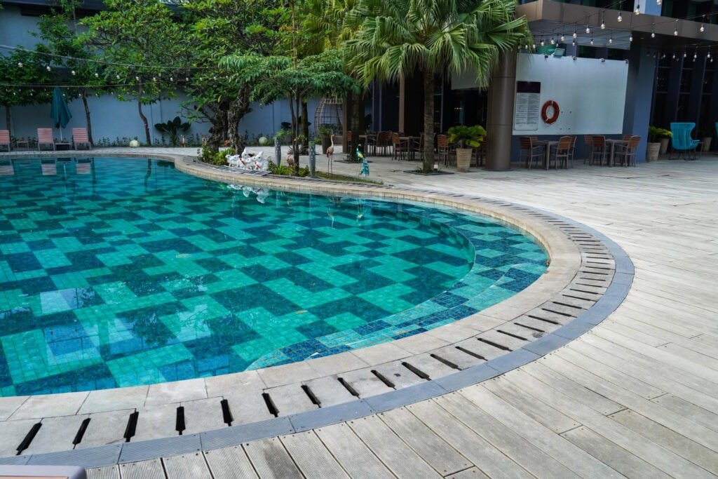 Resort-inspired poolside tiles in aqua hues delivering durability, comfort, and timeless outdoor sophistication
